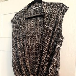 Sleeveless, semi sheer and draping piece will compliment any body type.